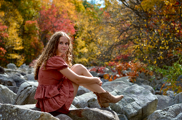 Emily sitting on rocks